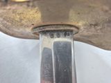 a knife that is sitting on top of a piece of metal