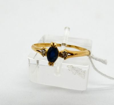 an image of a gold ring with a blue stone in it