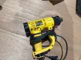 a yellow drill that is sitting on a table