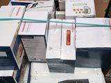 several boxes of electronics are stacked on top of each other on a table