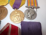 many medals that are laying on a table