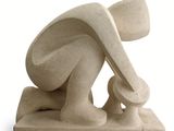 sculpture of a woman kneeling on her knees holding a surfboard