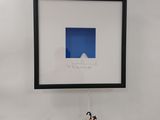 artwork hanging on the wall of a room with a picture of a penguin on it
