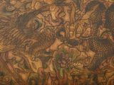 a picture of a dragon and a bird on the wall