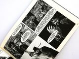 an open comic book with black and white illustrations on it