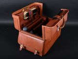 a brown suitcase with a handle and a handle on it