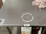 a picture of a stainless steel table with a clock on it