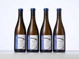 three bottles of wine sitting on top of a table next to each other