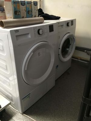 a white washer and a dryer sitting on top of each other