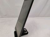 a tablet computer sitting on a stand on a white surface
