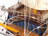 a model of a sailboat on a wooden table