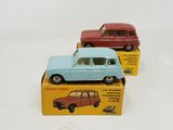 three small toy cars sitting on top of a box