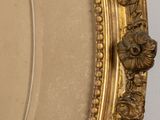 a gold frame with a picture of a man and a woman