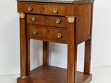 a small wooden table with a marble top on wheels