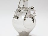 a glass vase with a bird on top of it
