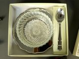 a glass bowl with a spoon and spoon rest in it