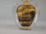 a glass bottle with a picture of a boat on it