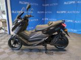 a picture of a motorcycle parked in front of a blue wall