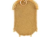 a close up of a gold purse on a white background