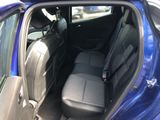 a blue car that is sitting in the back of the car