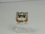 a close up of a gold ring with a bow on top of it