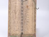 an old book with writing on it sitting on top of a table
