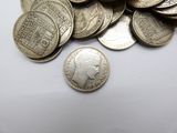 a pile of coins sitting on top of a white table