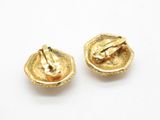 a close up of two gold colored buttons on a white surface