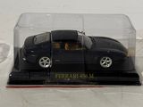a black toy car in a clear case