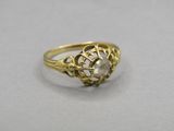 an image of a gold ring with a white stone in the center