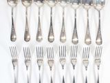 a lot of silver spoons and forks on the table