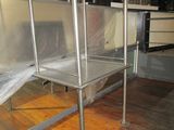 a metal bed with a sheet covering it in a room