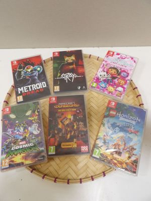 many video games sitting on a basket on a table