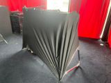 a black umbrella sitting on top of a black table