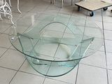 a glass table that is sitting on a tile floor