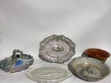 many different plates and bowls on a white surface