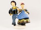 a figurine of a man and a woman standing next to each other