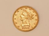 a close up of a gold coin with a woman ' s head on it