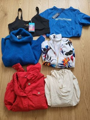 four pieces of clothing laid out on the floor on a wooden floor