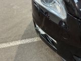 a close up of a car ' s headlight on a parking lot