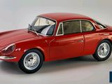 a red model of a car on a white background