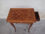a small wooden table with a drawer on it