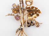 an image of a gold brooch with flowers and leaves