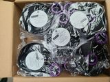 six rolls of black and purple tape in a cardboard box