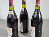 three bottles of wine that are sitting on a table