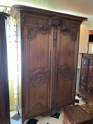 an image of a bedroom with a large wooden armoire