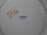 a white plate with a blue and red design on it