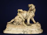 marble sculpture of a lion and a lioness on a rock
