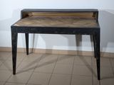 a black table with a wooden top on a tiled floor