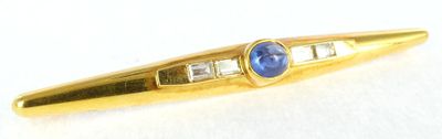 an image of a blue stone and diamond pen on a white surface